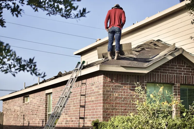 Professional roofer working on a residential roof in Downtown Frederick